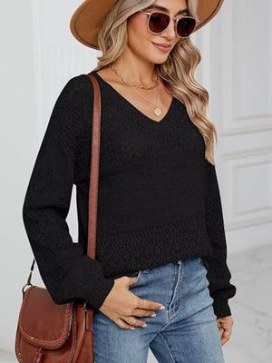 Black eyelet stitch V-neck pullover sweater with long sleeves and textured knit details.
