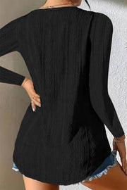 Black textured diamond-stitch long sleeve button-down blouse with a relaxed fit.