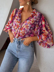 Vibrant floral print button-up shirt with bishop sleeves and a classic collar.