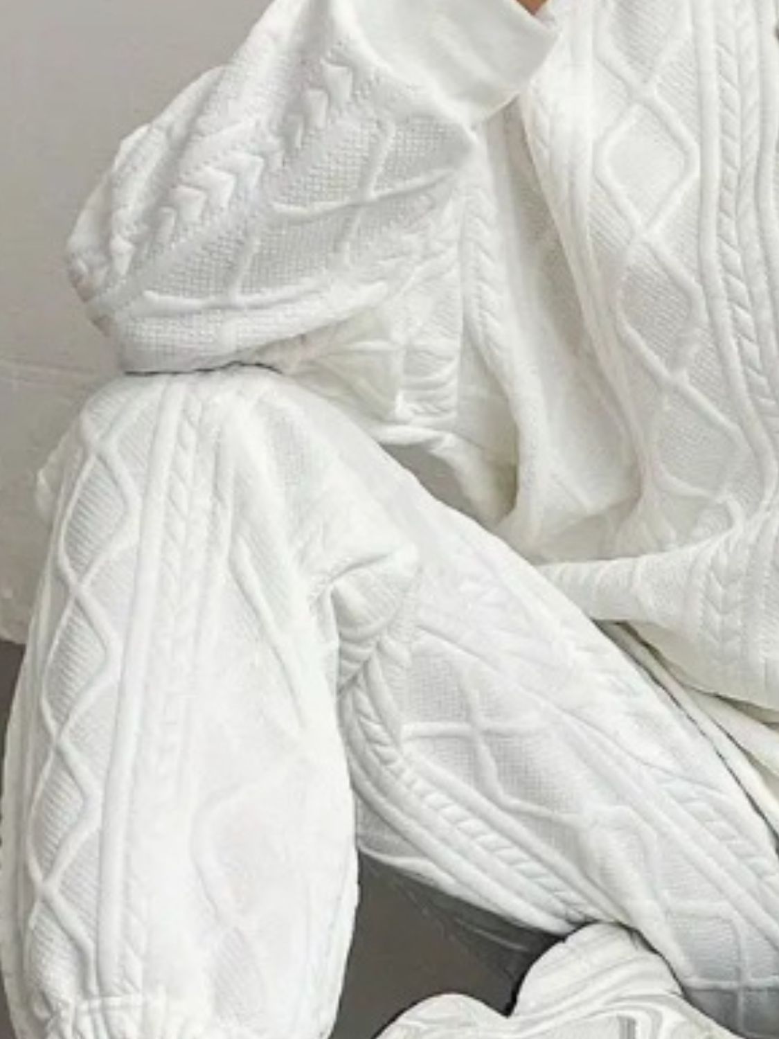 White cable knit loungewear set with textured pattern detail.