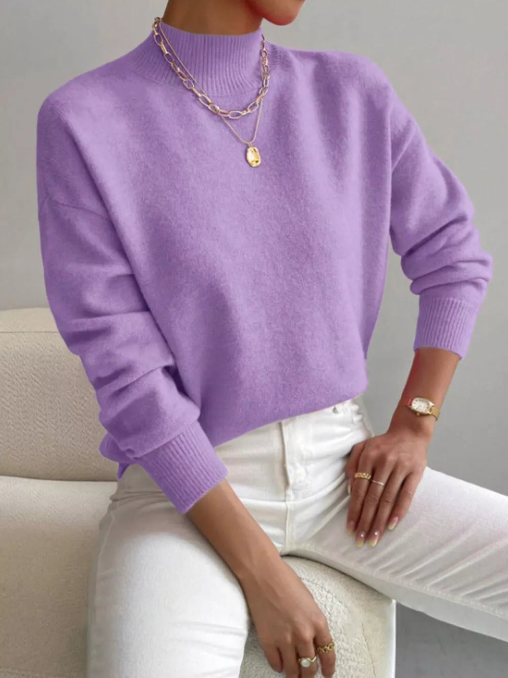 Lavender mock neck knit sweater with dropped shoulders, acrylic fabric, and ribbed cuffs.