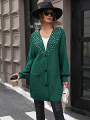 Green cable knit cardigan with pearl embellishments and pockets.