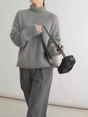 Gray acrylic turtleneck sweater with dropped shoulders and ribbed cuffs and hem.