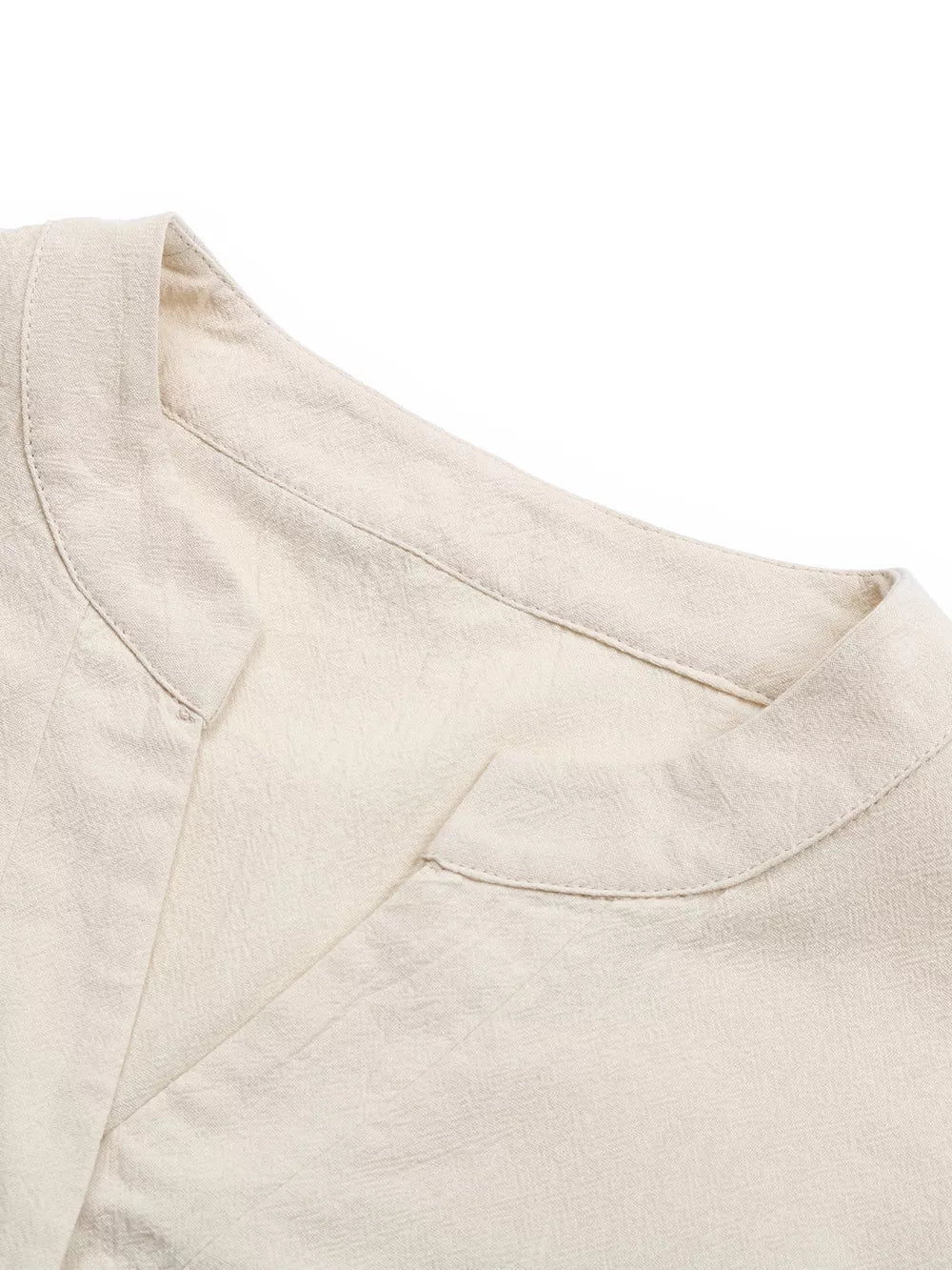V-neck buttoned cotton mini dress in apricot with a subtle ruffle detail.