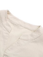V-neck buttoned cotton mini dress in apricot with a subtle ruffle detail.