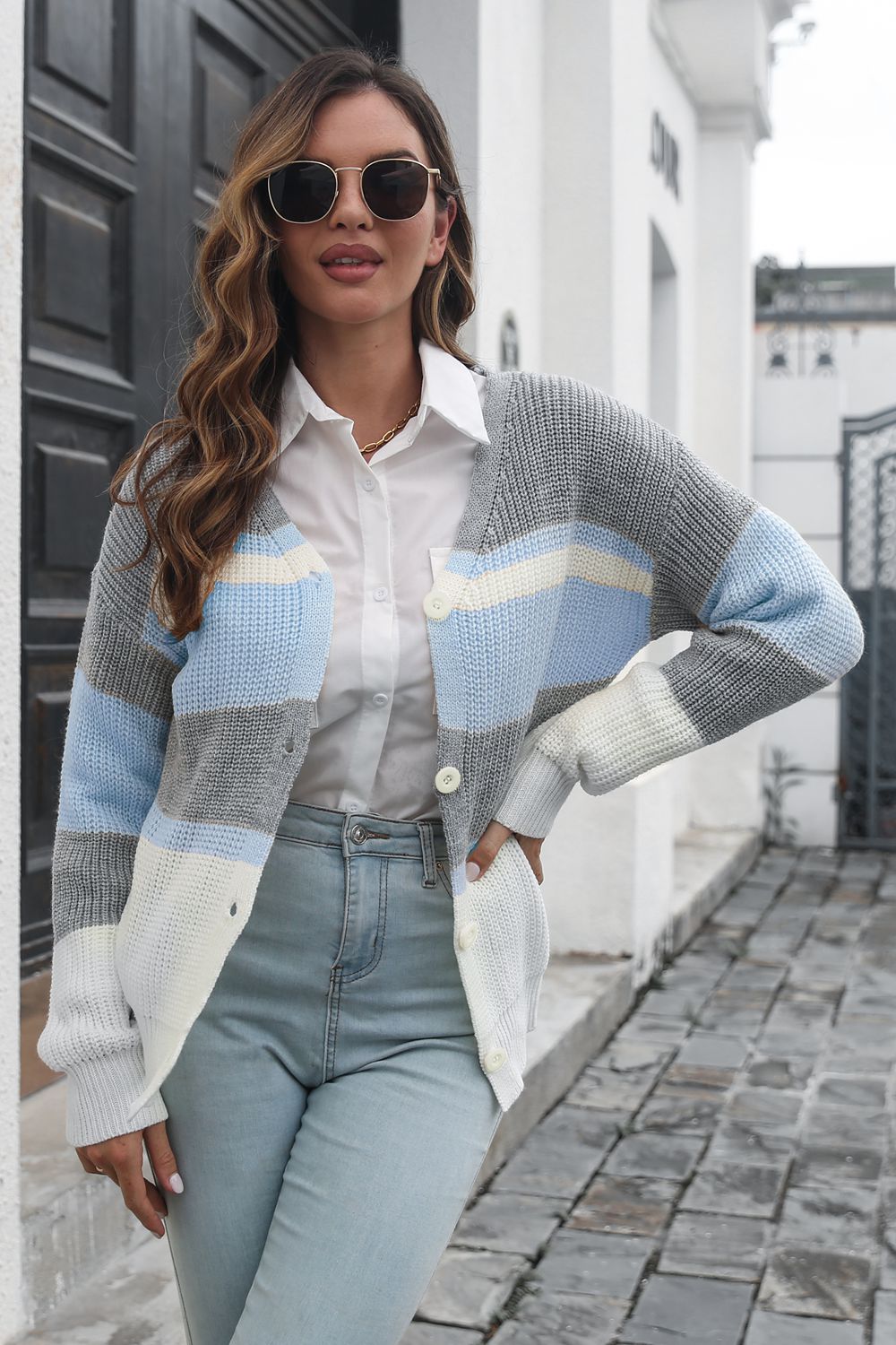 Horizontal stripe knit cardigan with button closure in grey, white, and light blue acrylic.