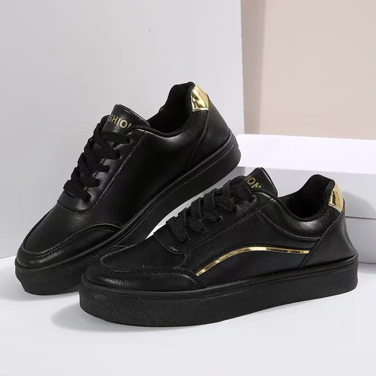 Black sneakers with gold metallic trim and heel detail