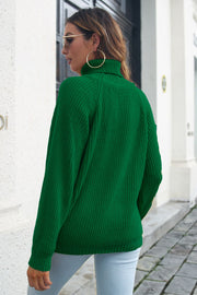 Dark green ribbed turtleneck sweater with raglan sleeves.