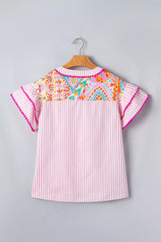 Pink striped blouse with vibrant patchwork yoke and ruffled sleeves with pom-pom trim.
