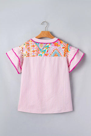 Pink striped blouse with vibrant patchwork yoke and ruffled sleeves with pom-pom trim.