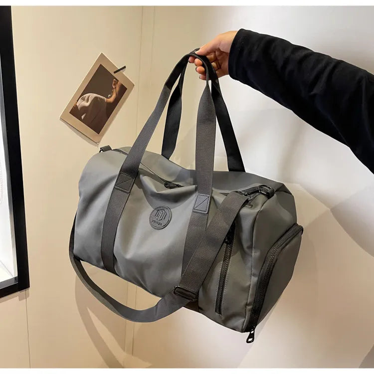 Dark Gray duffel bag with contrast straps and zippered pockets, ideal for gym or travel.