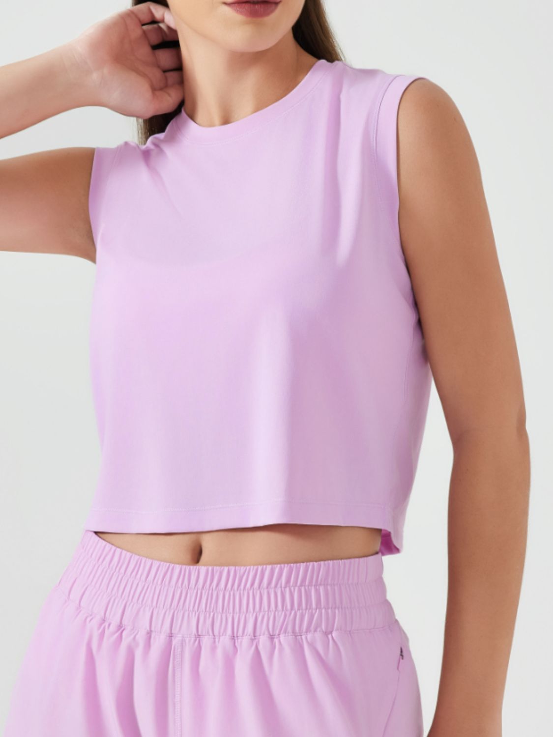 Sculpted crop active muscle tee in Pink Purple, sleeveless, crewneck, relaxed fit.