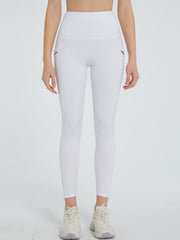 White pocketed leggings with a high waist and seam details.