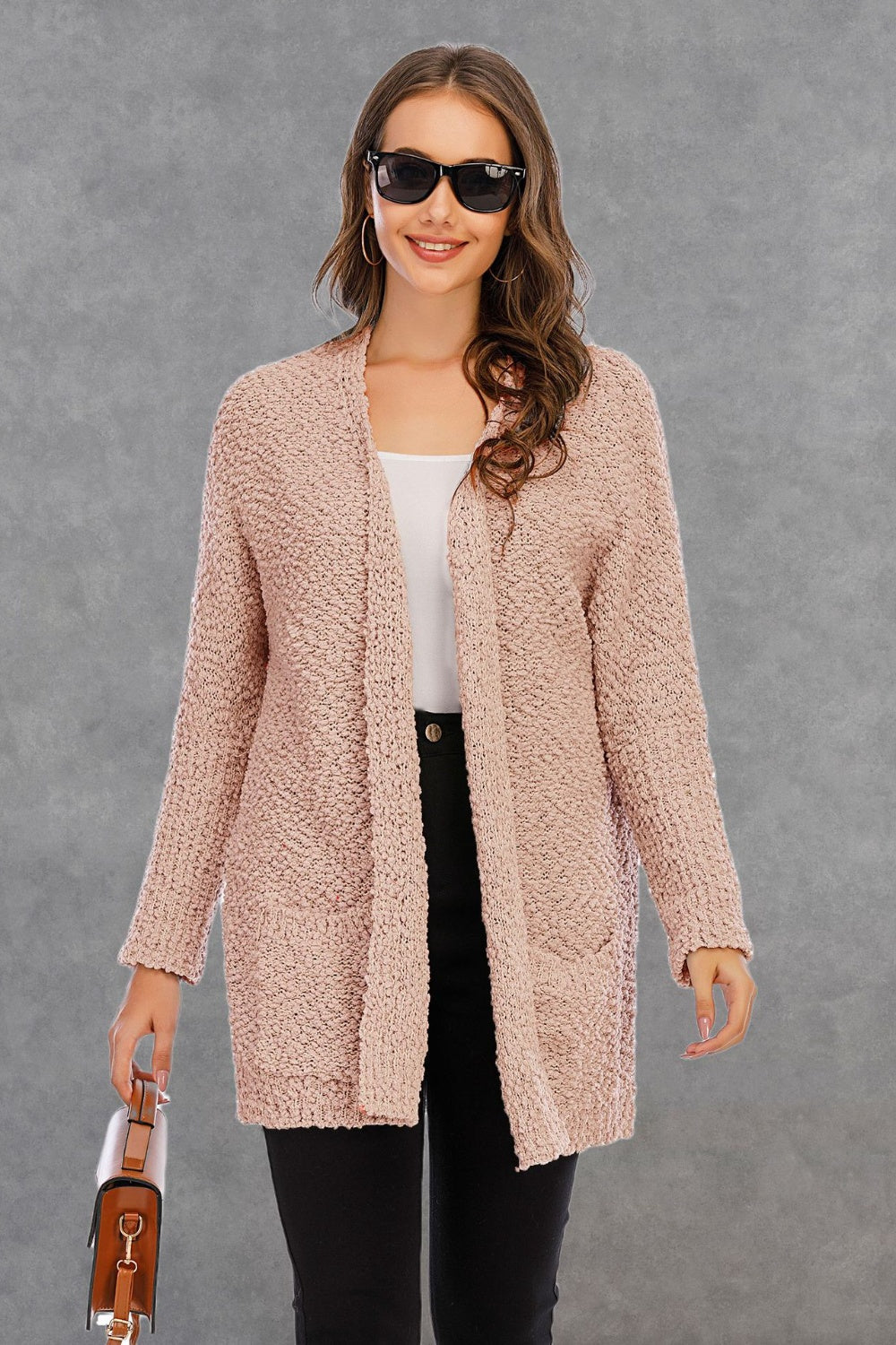 Textured cocoon cardigan in watermelon pink with patch pockets and open front.
