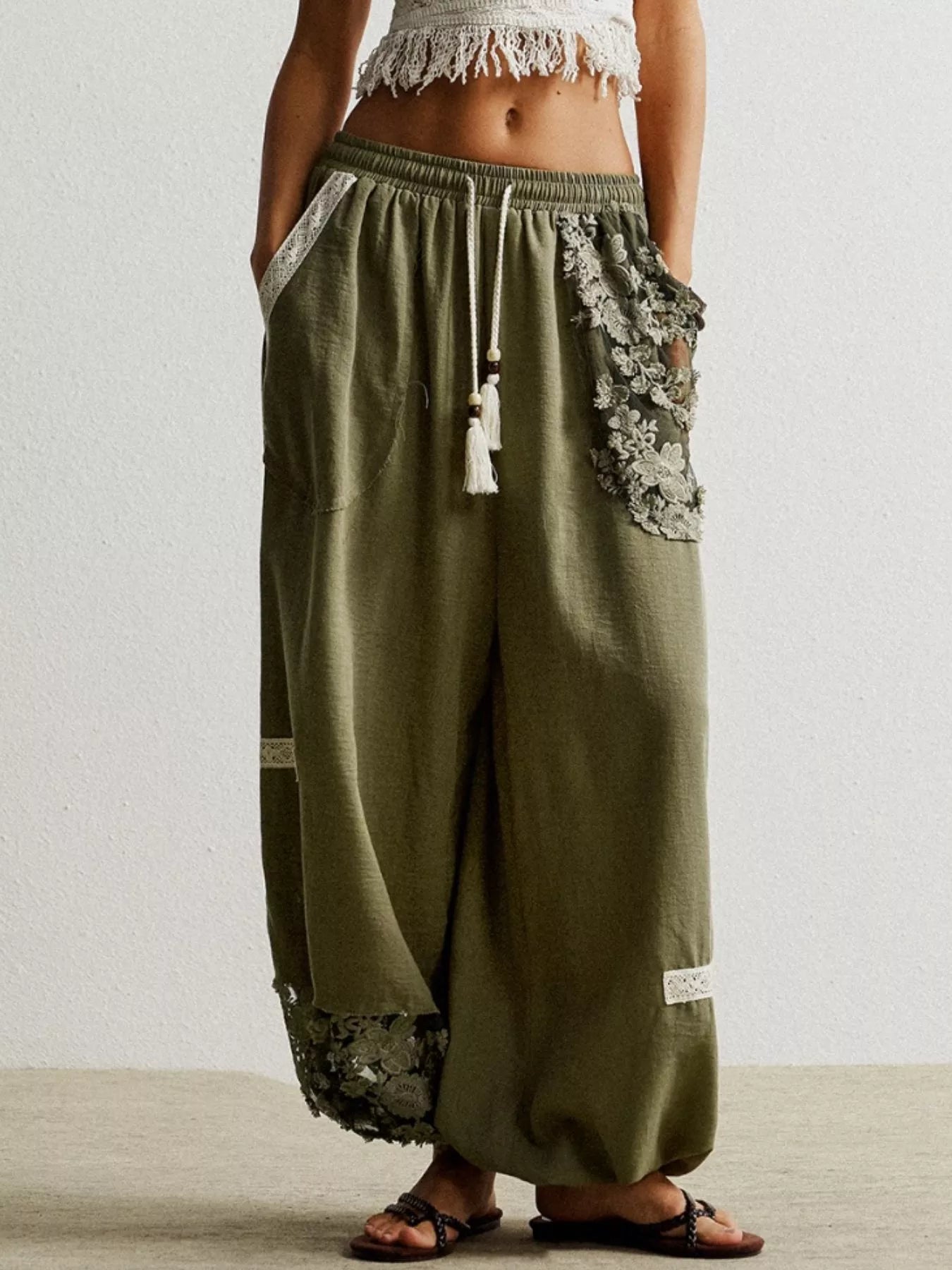 Moss drawstring harem pants with lace trim details and tassel drawstring.
