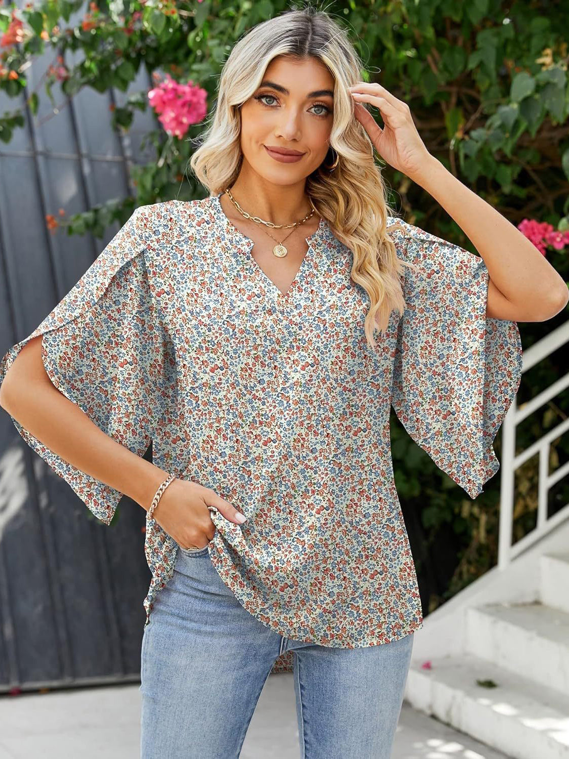 Floral print blouse with flutter sleeves and V-neck, made of 100% polyester.