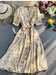 Apricot floral v-neck midi dress with belted waist and button-down front.