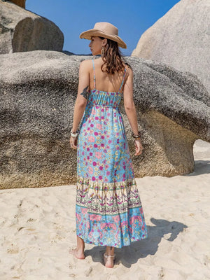 Maxi dress with floral print, spaghetti straps, tiered border print skirt, and tassels.