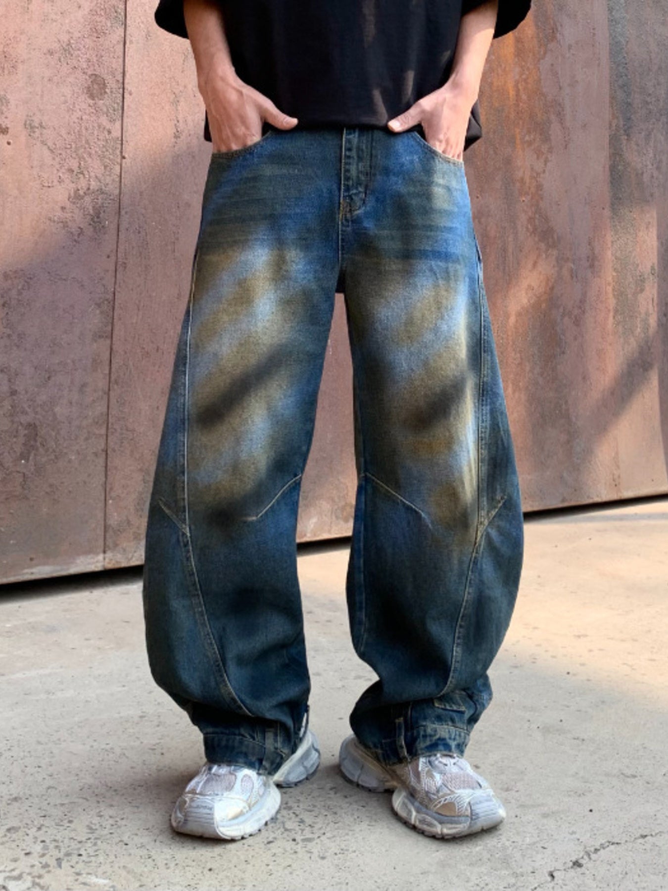 Men's dark distressed wide-leg denim jeans with a relaxed fit.