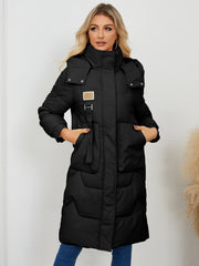 Black quilted puffer parka with hood and buckle detail