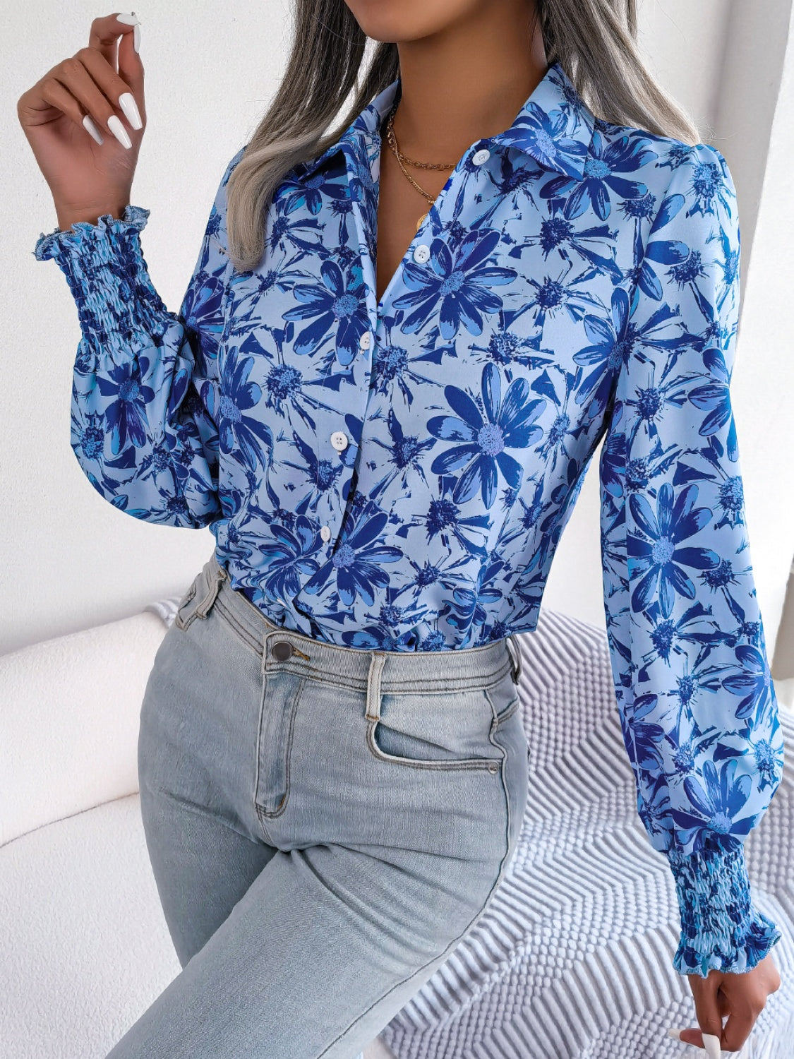 Royal blue floral print shirred cuff blouse with button front and collar.