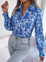Royal blue floral print shirred cuff blouse with button front and collar.