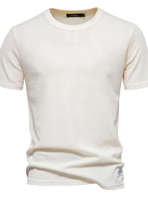 Ivory textured crew-neck t-shirt knit with short sleeves and a waffle knit pattern.