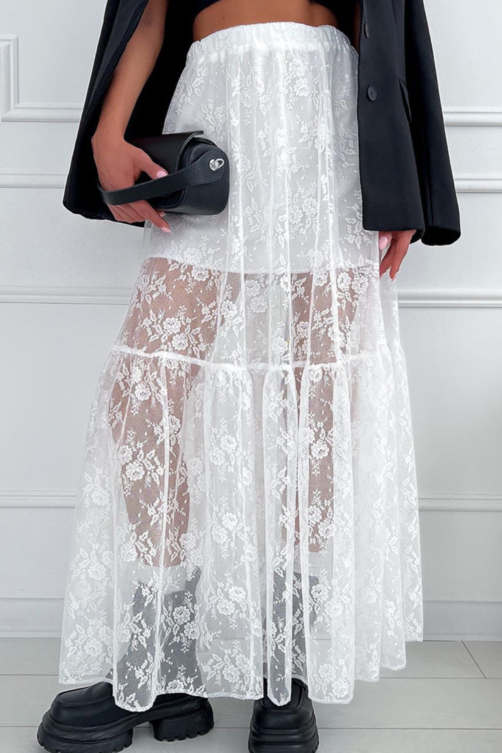 White lace maxi skirt with tiered floral pattern, sheer overlay, and elastic waist.