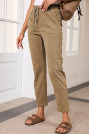 Khaki corduroy drawstring trousers with slant pockets and a relaxed fit.