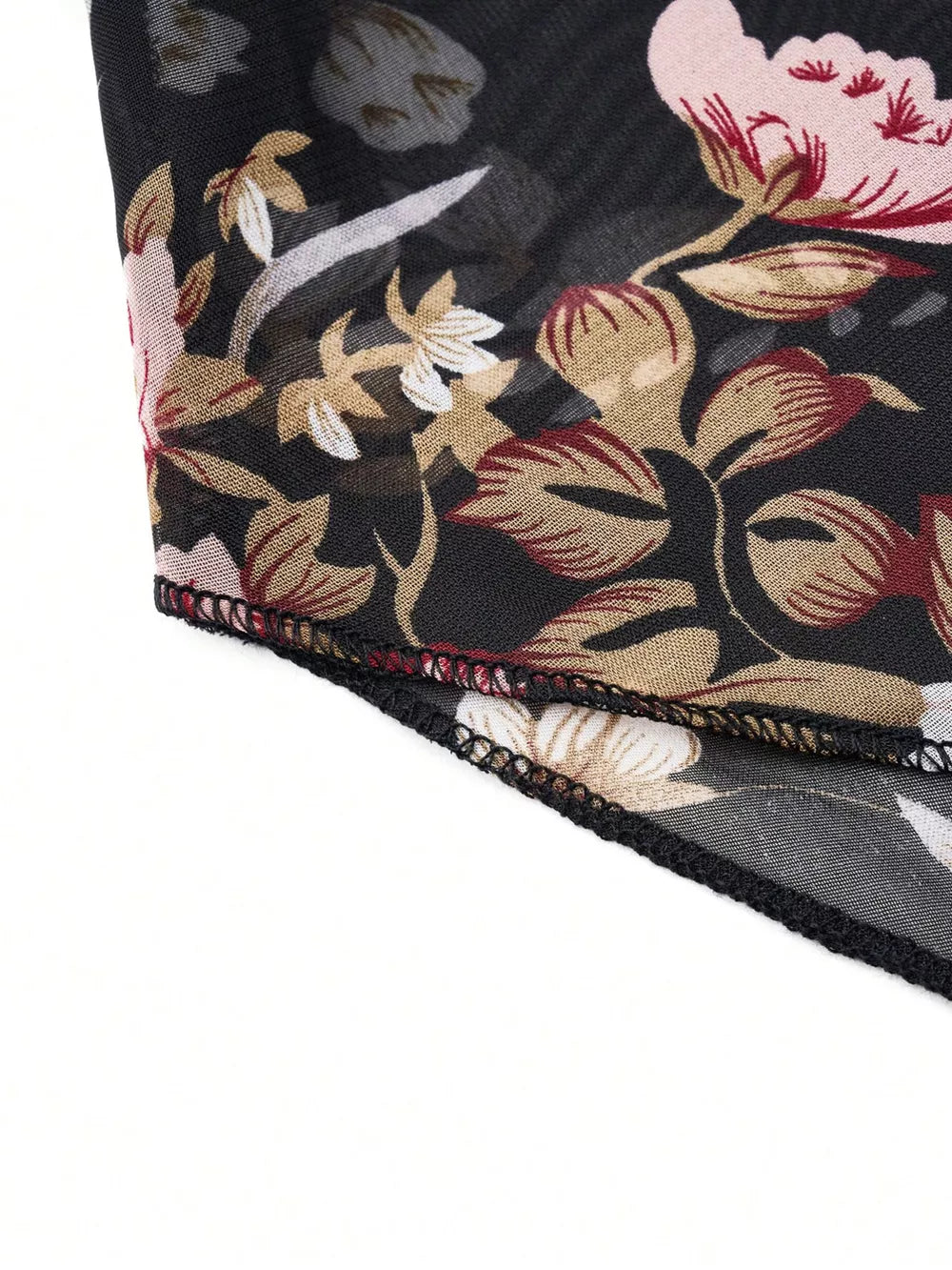 Sheer black blouse with vibrant floral print, round neck, and draped detail.