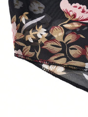 Sheer black blouse with vibrant floral print, round neck, and draped detail.