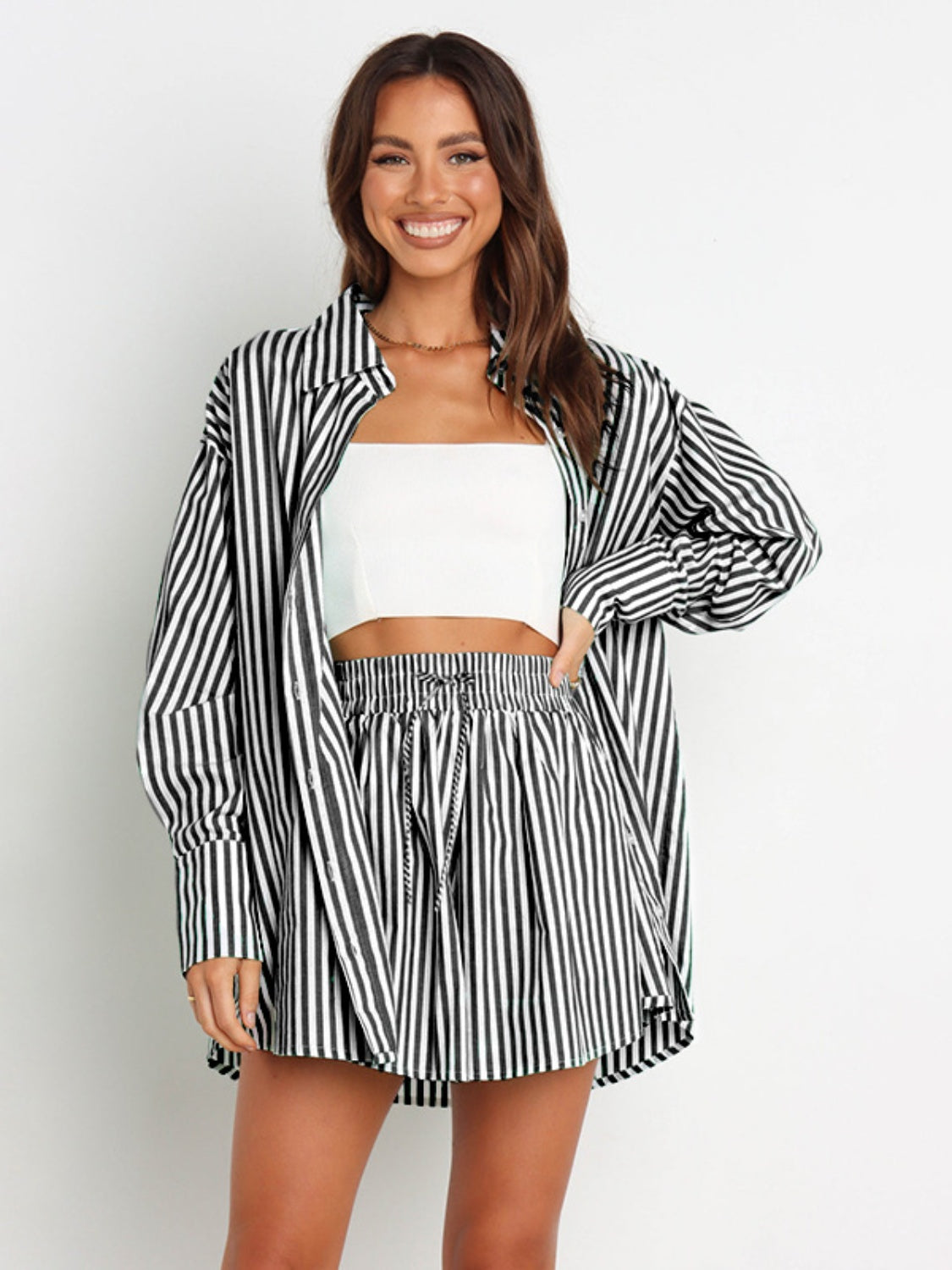 Oversized black and white stripe shirting set with drawstring shorts and a long sleeve button-up shirt.