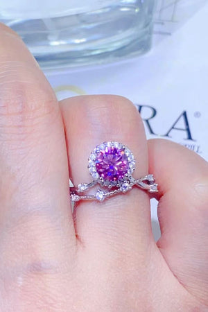 Pink moissanite halo ring with sterling silver band and accent stones.