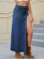 Denim maxi skirt in medium wash with a high slit and buttoned front.