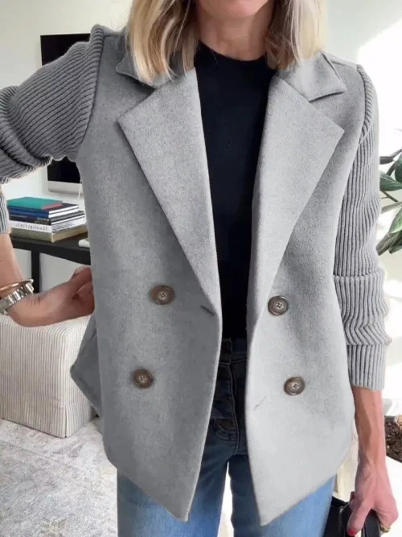 Gray double-breasted wool blend blazer with contrasting ribbed knit sleeves and button detail.