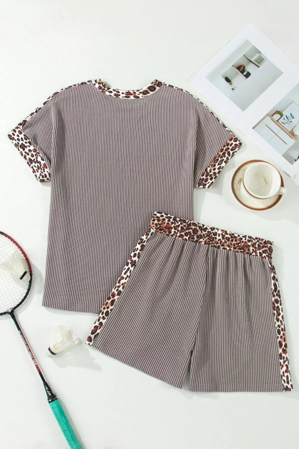 Brown ribbed knit two-piece set with leopard trim on neckline, sleeves, and shorts.