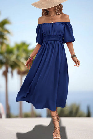 Off-shoulder puff sleeve empire midi dress in dark blue with smocked waist and A-line skirt.