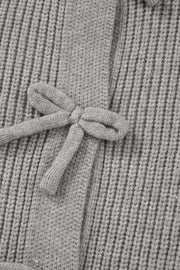 Gray ribbed knit cardigan with a tie-front detail and bow accent.