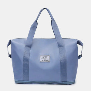 Dusty Blue nylon shopper bag with dual handles and a central label.