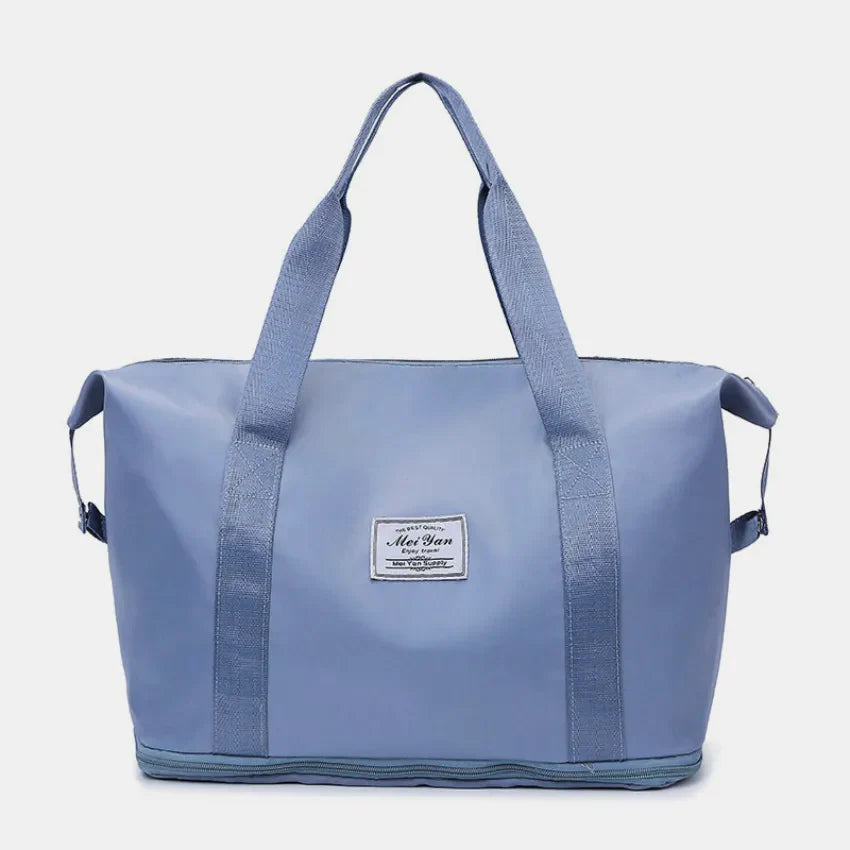 Dusty Blue nylon shopper bag with dual handles and a central label.