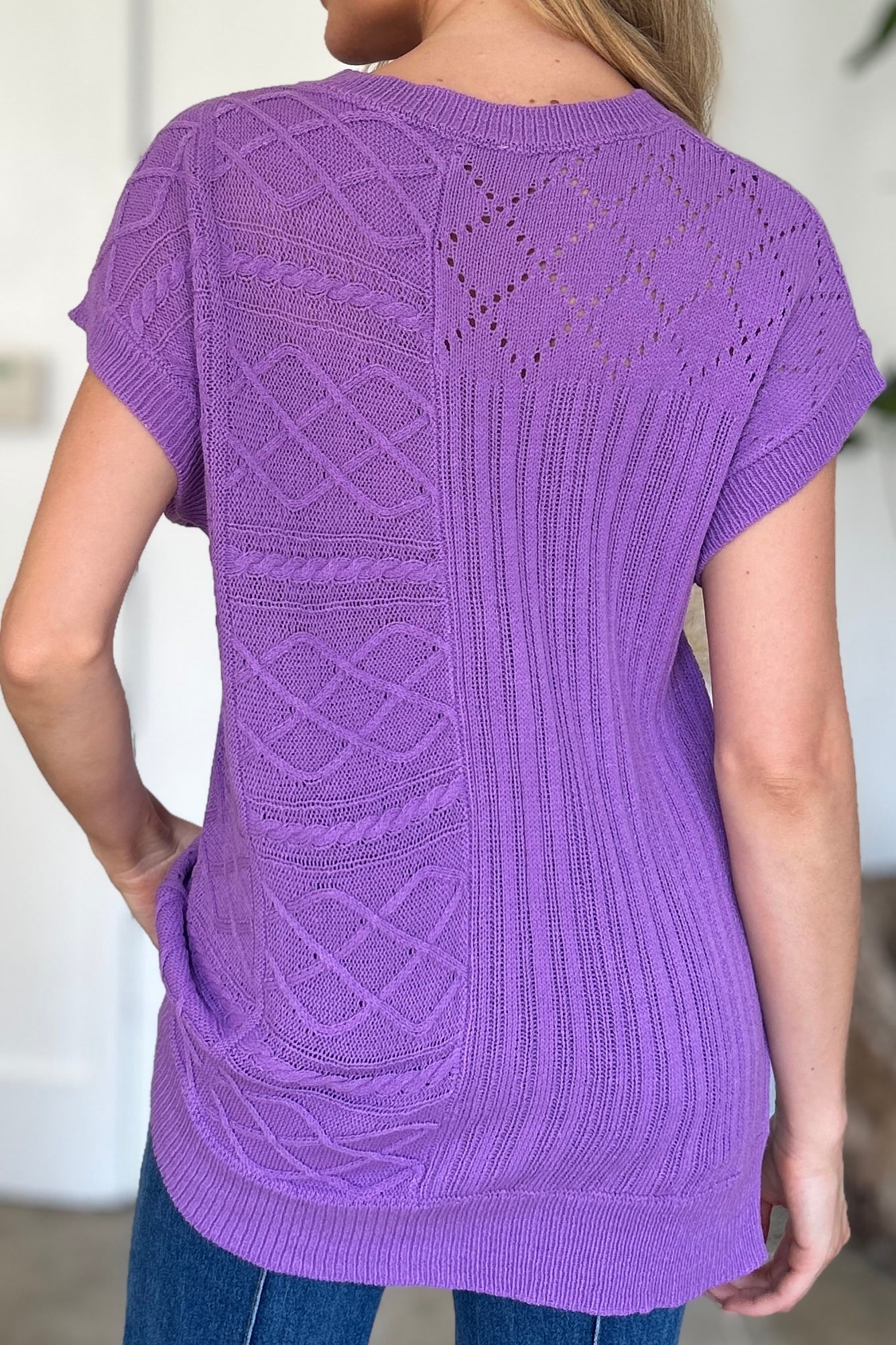 Purple knit patchwork top with cable and lace details, short sleeves.