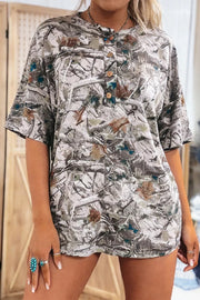 Earthy camouflage print henley t-shirt with button detail and short sleeves.