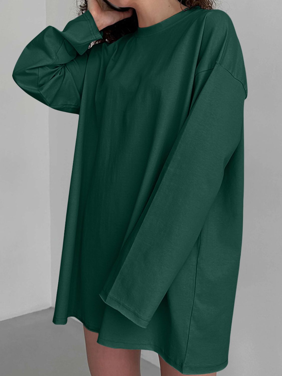 Oversized dark green cotton jersey top with long sleeves and a crew neck.