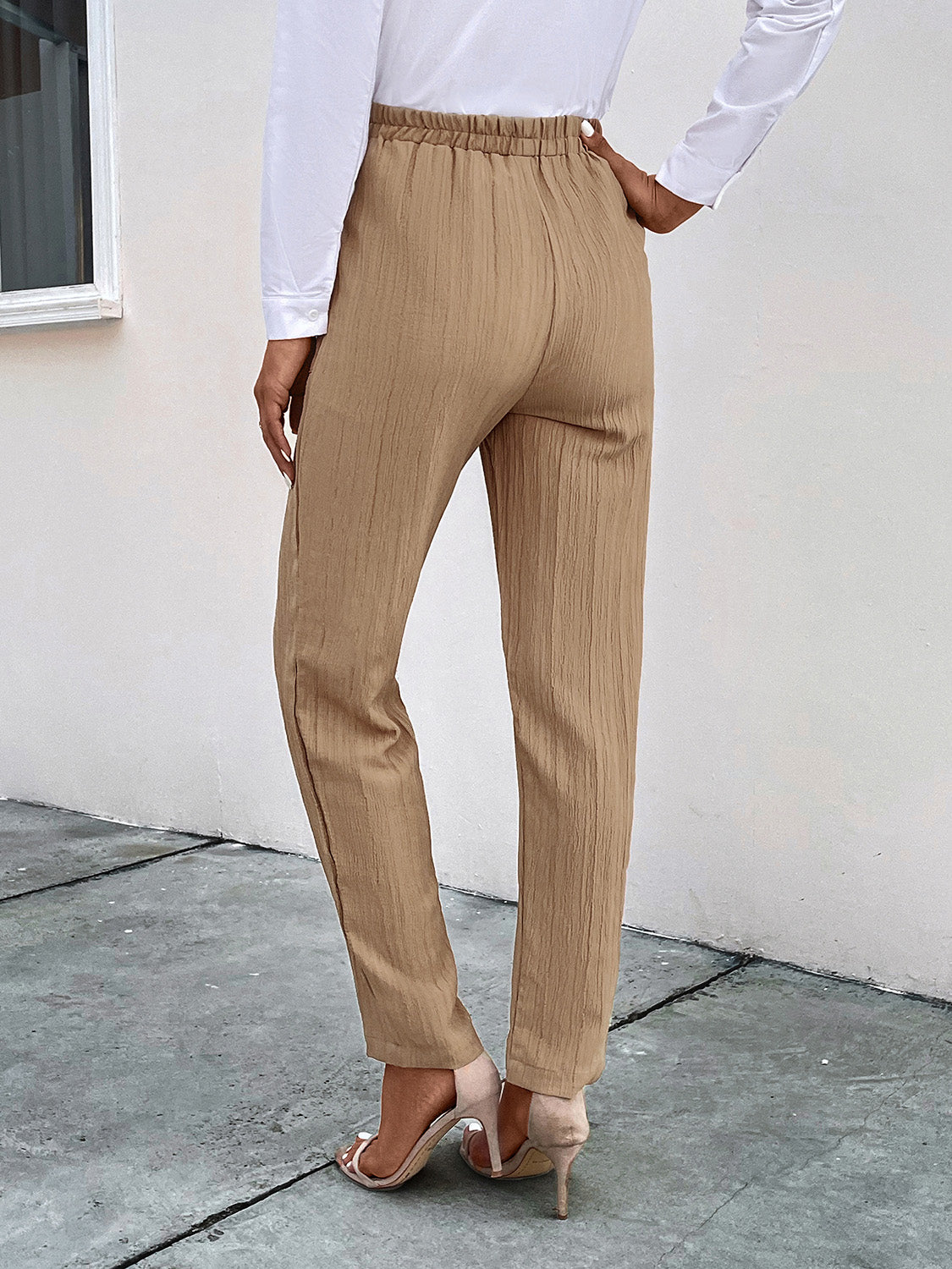 Tan textured tapered trousers with drawstring waist and elastic waistband.