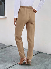 Tan textured tapered trousers with drawstring waist and elastic waistband.