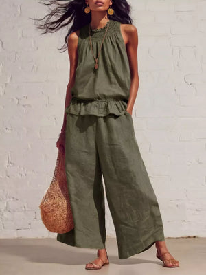 Army green smocked peplum top and flowing pants set with ruffled hem and wide legs.