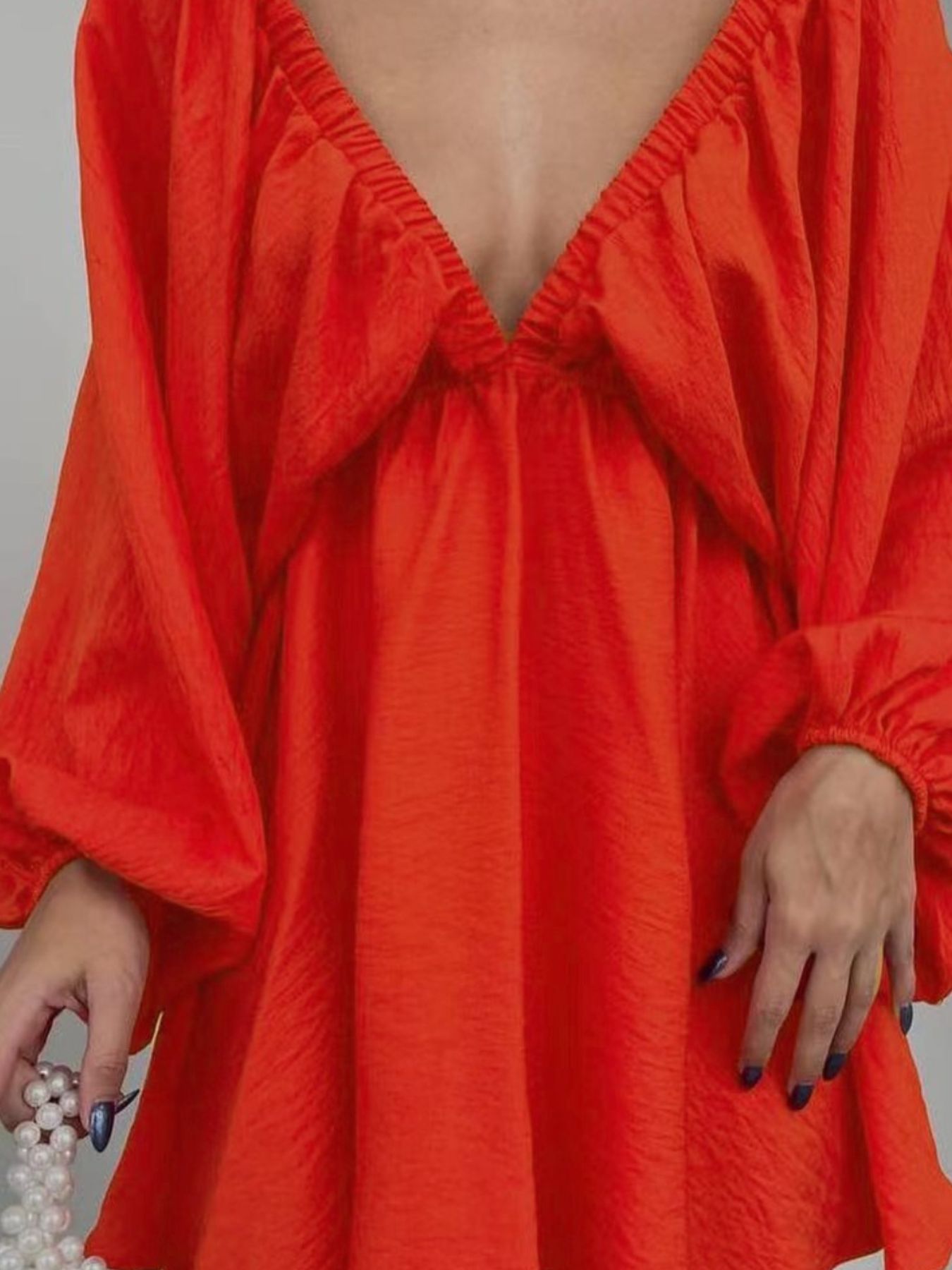 Ruched V-neck dress in Scarlet with balloon sleeves and cinched cuffs.