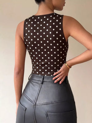 Brown polka dot sleeveless bodysuit with a cowl neck detail.