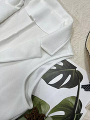 White longline vest coat with textured fabric and notch collar.