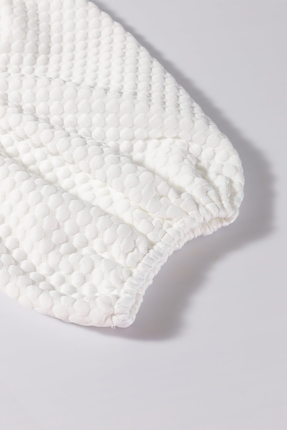 White textured quilted puff sleeve blouse with gathered cuff detail
